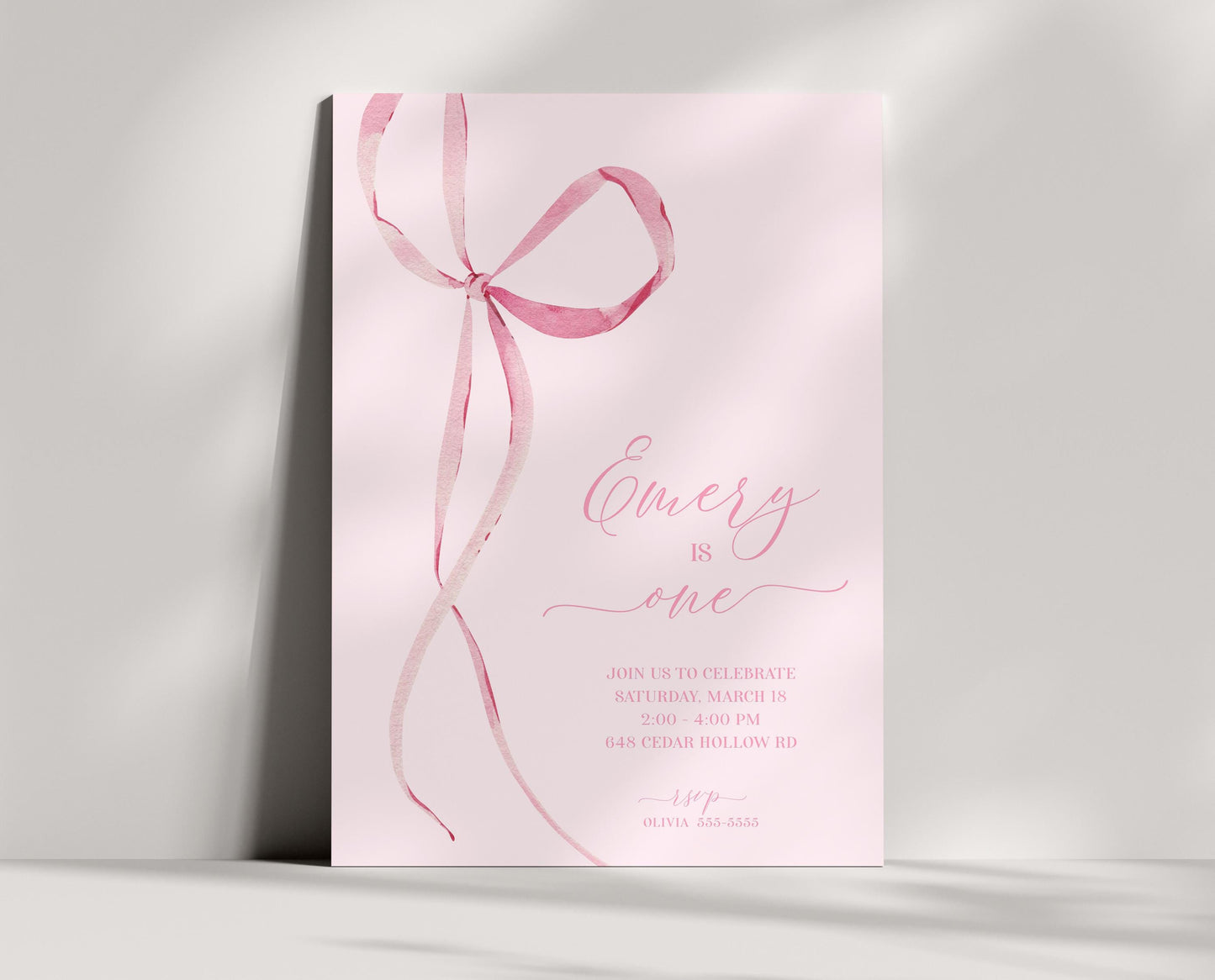 coquette aesthetic pink bow birthday invitation. editable template. Pale pink background with a watercolor graphic of thin pink bow with long ribbons along left side of invite. Party details in a modern script ballerina inspired font on right