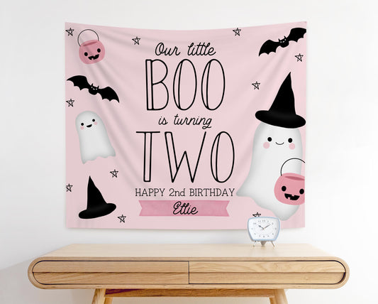 pink and black girl 2nd birthday backdrop for halloween theme.  graphics of bats, ghosts, pumpkins and witches hats.  Pale pink background in modern playful design reads &quot;Our little BOO is turning TWO, Happy 2nd Birthday Ellie&quot;