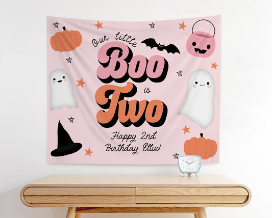 Pale pink, orange and black party backdrop that reads &quot;Our little BOO is TWO, Happy 2nd Birthday Ellie!&quot;.  Fun playful modern graphics of pumpkin, witch hat, ghosts and trick or treat bucket.  Retro font in orange and pink