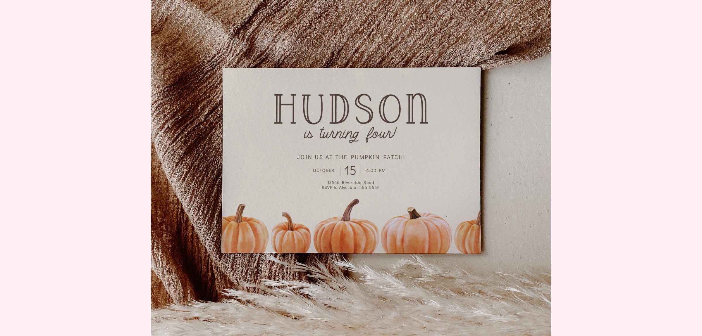 A fall-themed baby shower invitation card with the name 'HUDSON' and 'is turning four!' printed on it, styled on a textured brown faux fur surface against a light pink background.