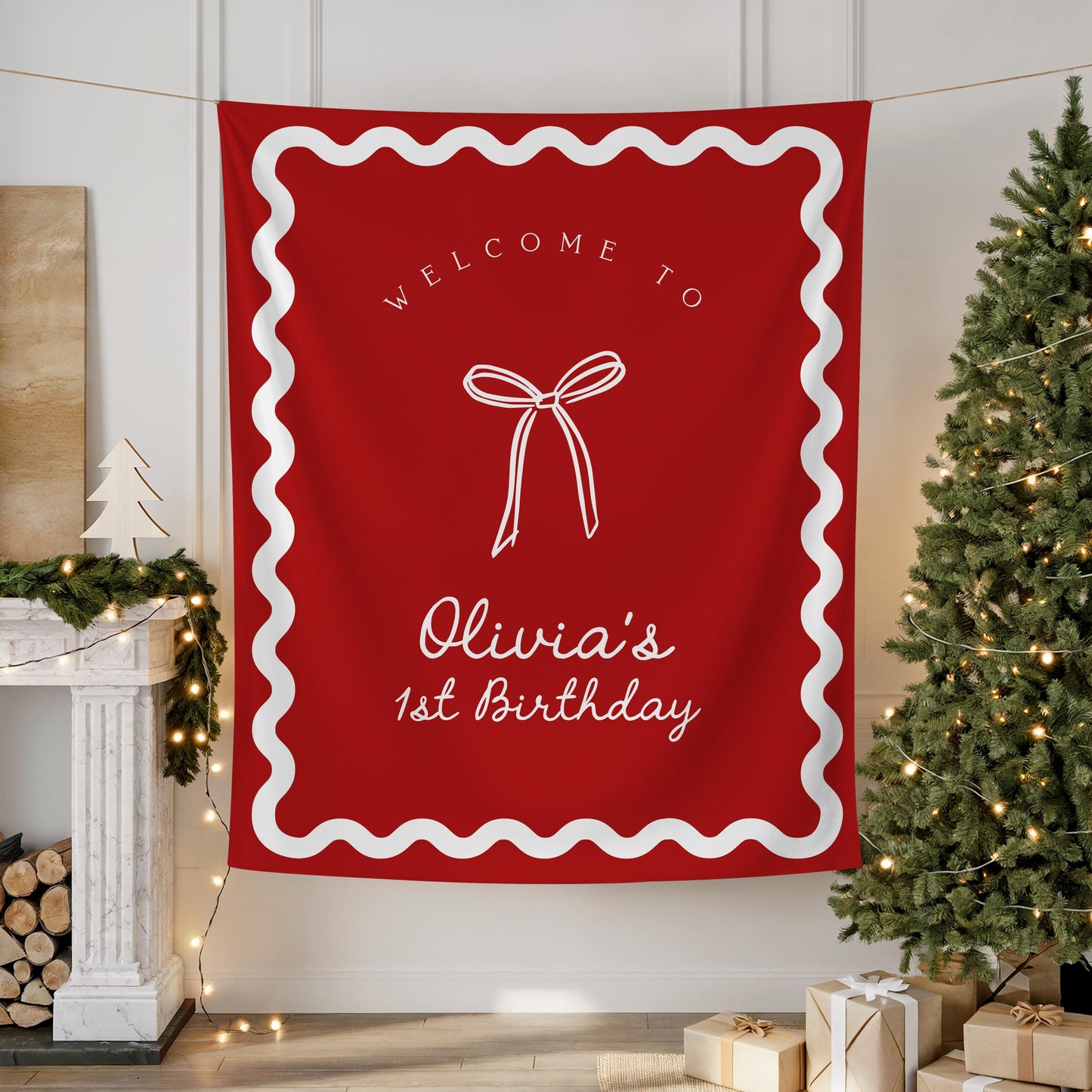Red Christmas birthday backdrop with white wavy border, coquette bow graphic, and text “Welcome to Olivia&#39;s 1st birthday” hanging on wall.