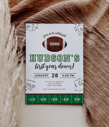 first year down football birthday invitation with watercolor football graphic and play outlines
