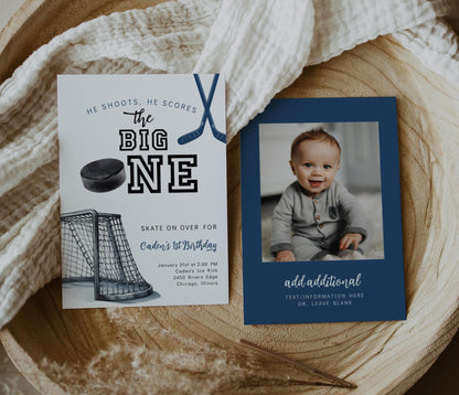 Two-sided hockey first birthday invitation with text “The Big ONE” featuring hockey sticks, puck, and net on one side and a customizable photo space on the other.