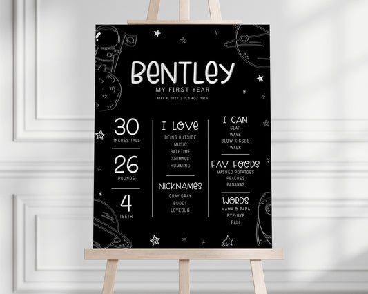 Black and white space first birthday milestone stats board.  editable template. Black background with white hand drawn like graphics of astronaut on moon, planets, rocket ship and stars.
