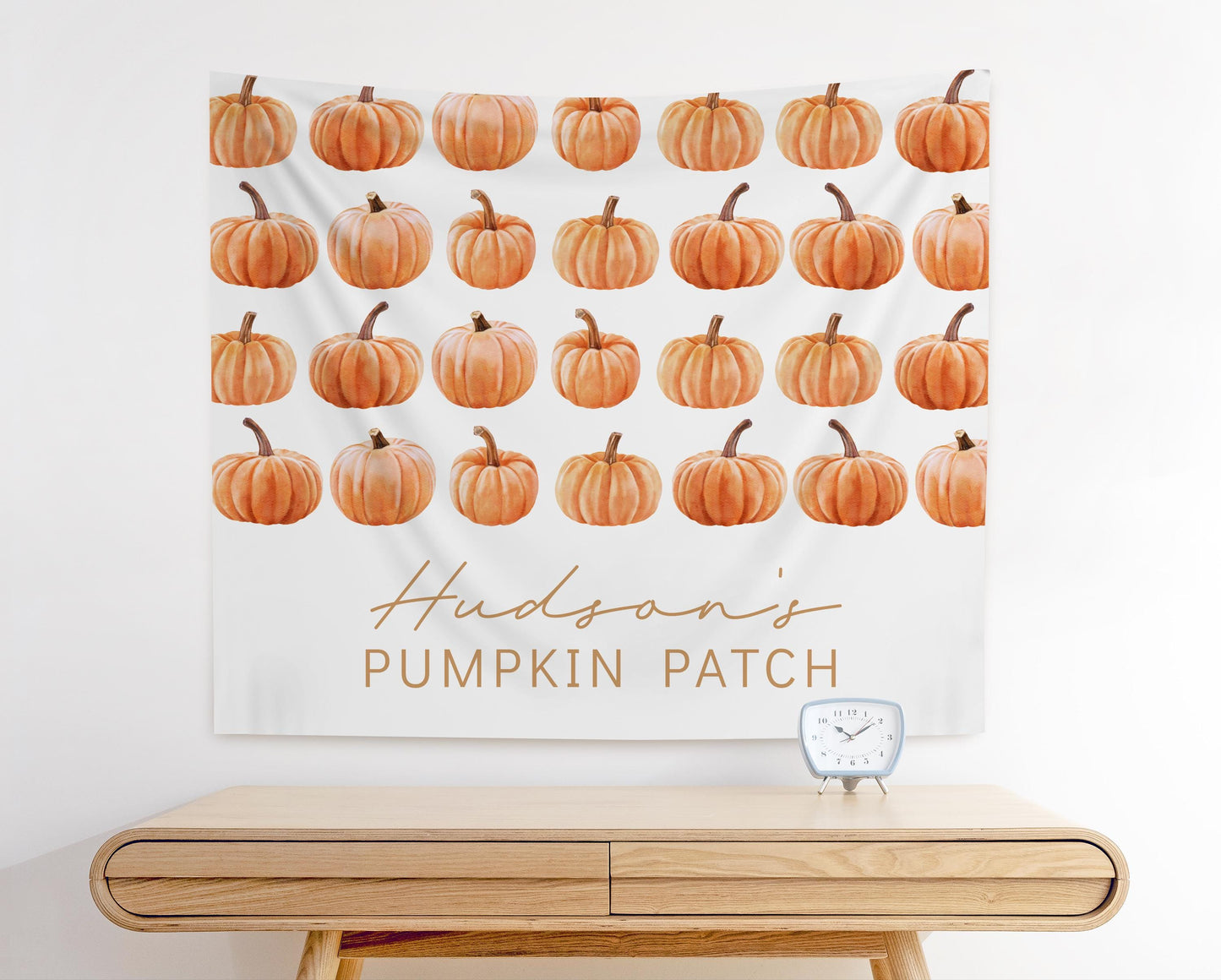 fabric backdrop wall hanging for fall pumpkin themed party.  rows of watercolor pumpkin graphics.  bottom space reads "Hudson's Pumpkin Patch".  Modern minimalist design