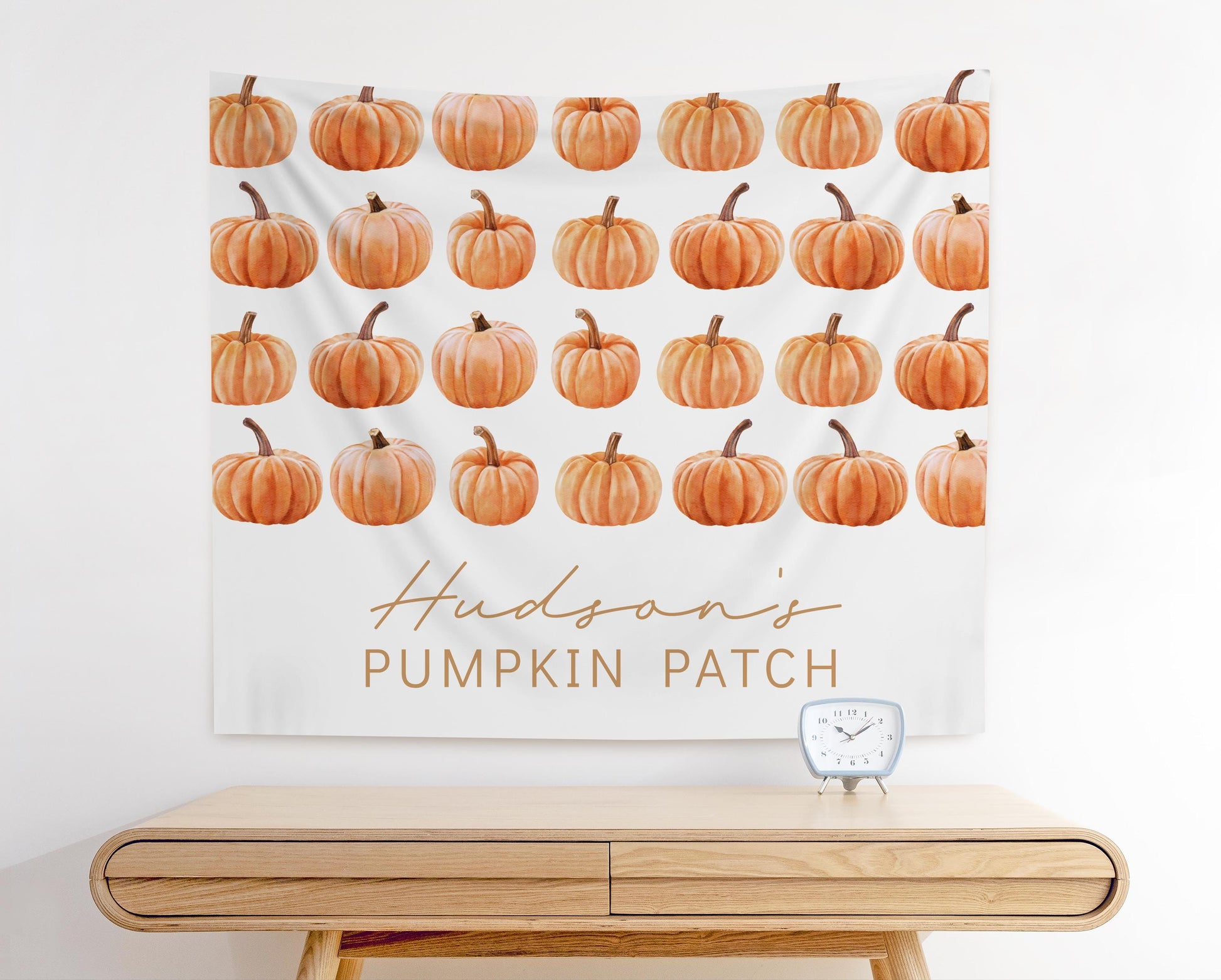 fabric backdrop wall hanging for fall pumpkin themed party.  rows of watercolor pumpkin graphics.  bottom space reads "Hudson's Pumpkin Patch".  Modern minimalist design