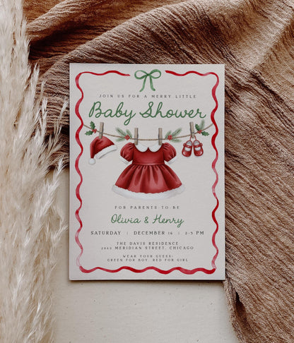 girl christmas baby shower invitation featuring santa hat, dress and shoes on clothesline.  red wavy ribbon border with green coquette bow.