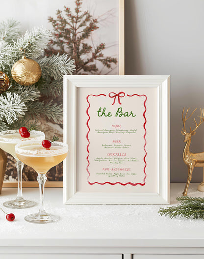 christmas bar drink menu in frame.  red wavy ribbon and bow border with green hand written font.