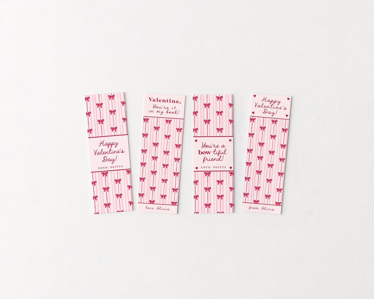 Pink bow Valentine bookmark printables with striped bow pattern and Valentine sayings, styled on a clean white background in a minimalist flat lay.
