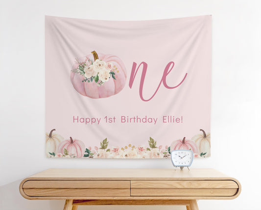 Boho floral pumpkin first birthday backdrop with pumpkin as the “O” in ONE and personalized text reading “Happy 1st Birthday Ellie”