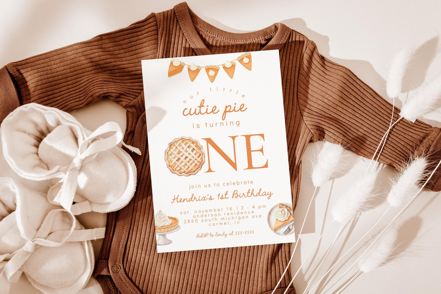 cutie pie first birthday party invitation with pumpkin pie graphics.  reads "our little cutie pie is ONE".  The "O" is replaced with a pie graphic.