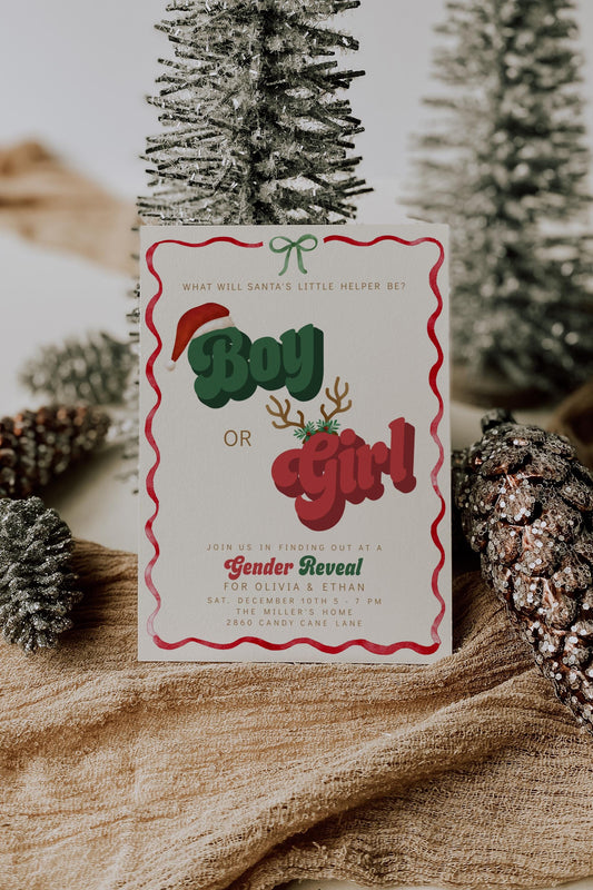 Christmas gender reveal invitation with retro red and green text reading “Boy or Girl,” featuring Santa hat, antlers, and wavy red border on a cream background.