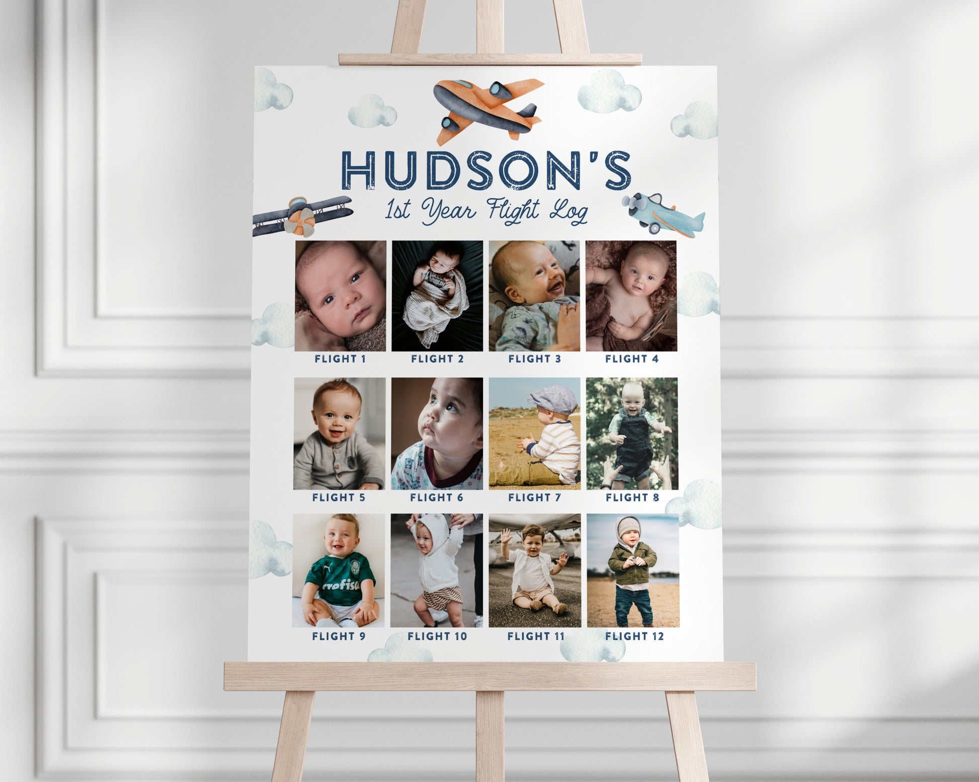 airplane birthday party photo board with 12 months of baby photos.  navy blue, turquoise and orange plane graphics and watercolor clouds.